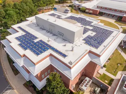 to view of a commercial building with TPO roof and solar panels